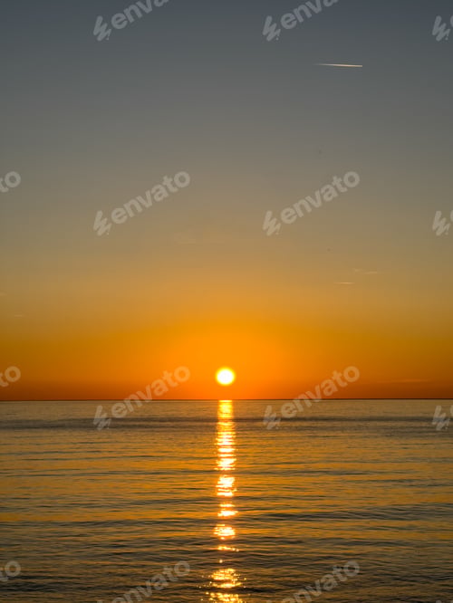 Preview: Sunny path in the sea against the backdrop of the sunset sky