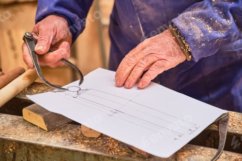 Preview: craftsman carpenter taking measurements from a plane to turn a piece of wood