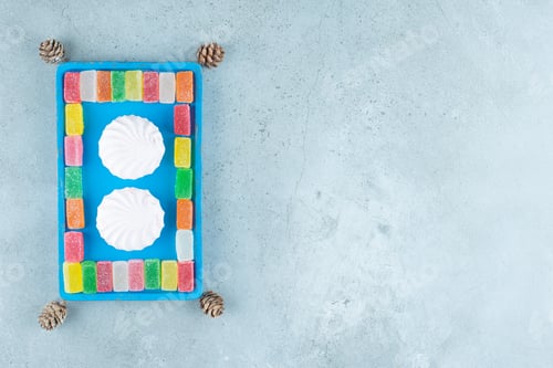 Preview: Cookies and marmelades on a blue platter on marble background