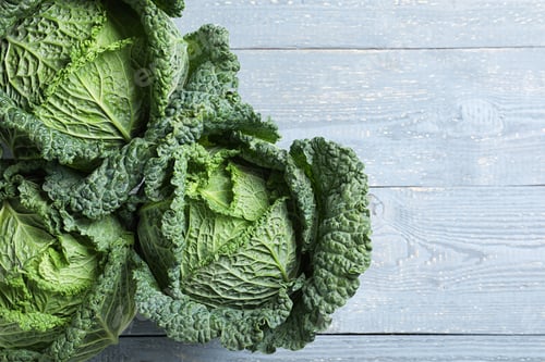 Preview: Fresh green savoy cabbages on grey wooden table, flat lay