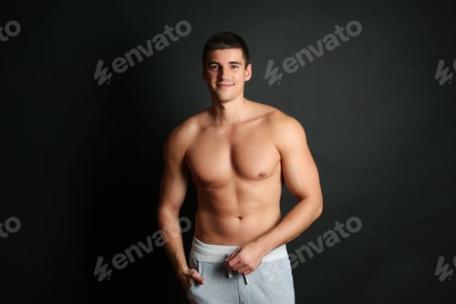 Preview: Man with sexy body on black background