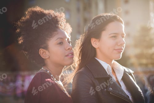 Preview: two multiethnic beautiful young woman black and white having fun