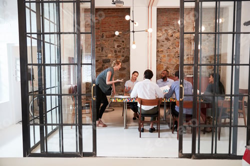Preview: Young woman managing a team meeting in a boardroom