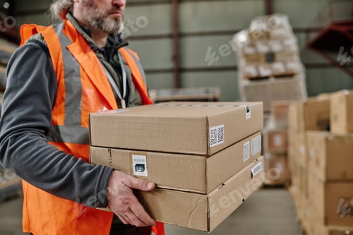 Preview: Warehouse worker unloading goods in storehouse