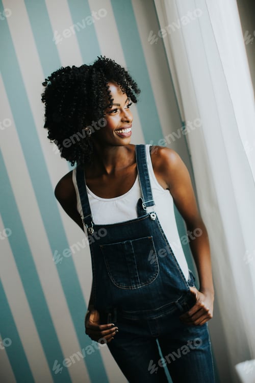 Preview: Pretty african american woman posing in jeans trousers