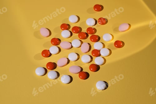 Preview: Colorful pills on a yellow background.