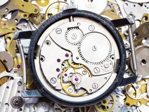 Preview: open mechanical wristwatch on pile of spare parts