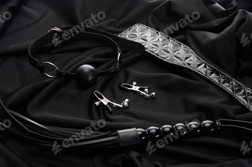 Preview: various sex toys on black textile background