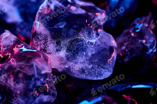 Preview: Close up View of Transparent Ice Cubes With Purple Illumination Isolated on Black