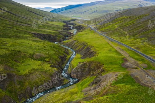 Preview: Aerial view of remote mountain road and river in the valley at north in Iceland, summertime