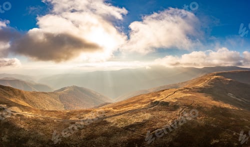 Preview: Long pathways running along mountains under blue sky