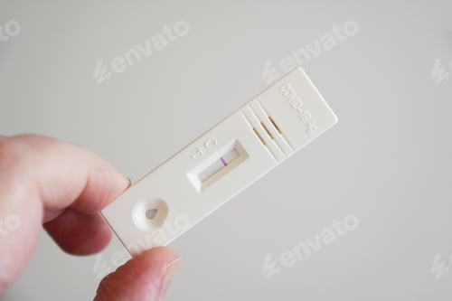 Preview: hand showing negative result on corona covid-19 antigen test cassette