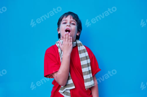 Preview: defiant boy scarf, looking and pointing at camera with the index finger of his right hand,