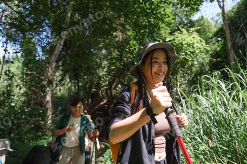 Preview: Young people enjoying nature while trekking in forest