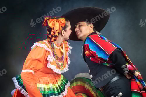 Preview: Latin Mexican couple with Jalisco, charro costumes A man and woman in traditional Mexican clothing