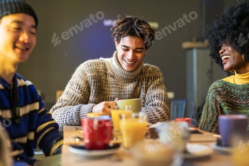 Preview: Multicultural group of students sitting at campus cafe bar to enjoy breakfast together.