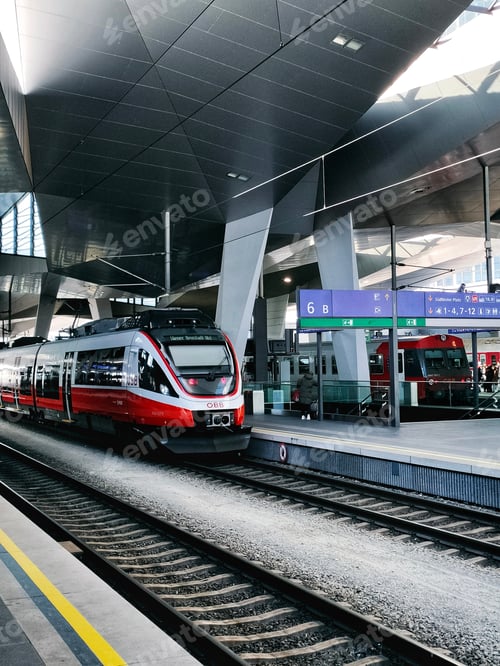 Preview: railway station with trains on the tracks and people on the platform