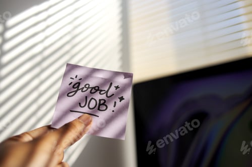 Preview: Hand Holding a Motivational Note in Bright Sunlight