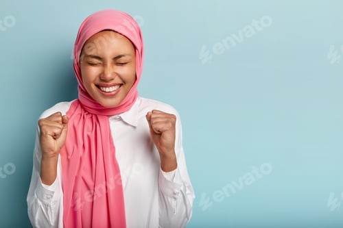 Preview: Smiling Woman with Arms Raised in Celebration
