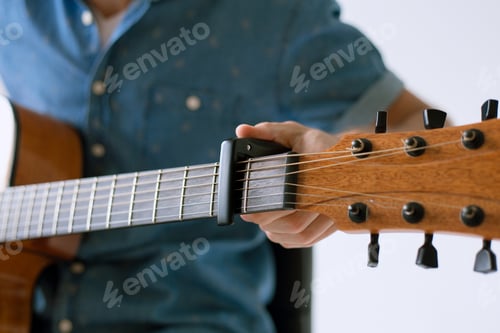 Preview: Handsome And Cheerful Guy Musician In A Shirt Playing Guitar