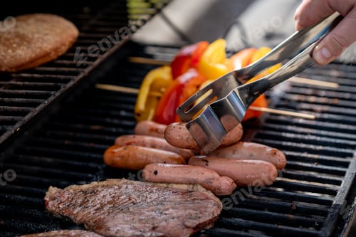 Preview: barbecue close up. grilling meat and vegetables. Grill tongs flip sausages. Summer leisure outdoors.