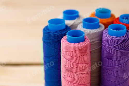 Preview: Close up of colored thread coils, thread spools background