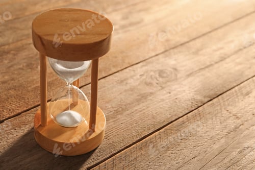 Preview: Hourglass with flowing sand on table. Time management