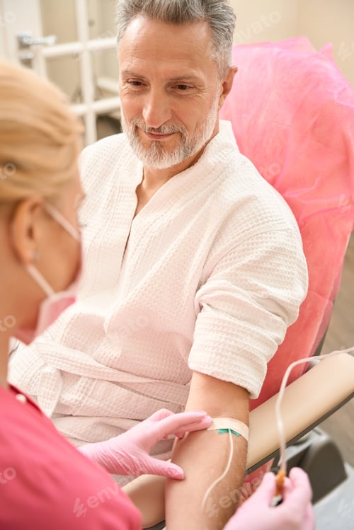 Preview: Middle-aged man is having an intravenous procedure in hospital