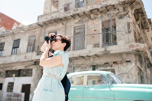 Preview: Traveler capturing the sights with binoculars in an old city district.
