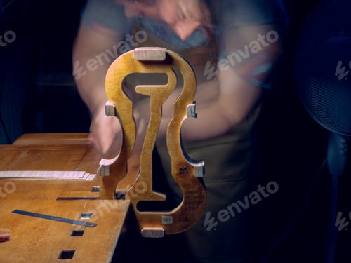 Preview: artisan violin maker luthier working with violin mould for center bot