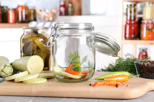 Preview: Jar with zucchini and dill on grey marble table indoors. Pickling vegetables