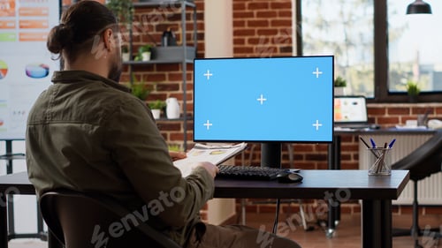 Preview: Office employee working on business using greenscreen display