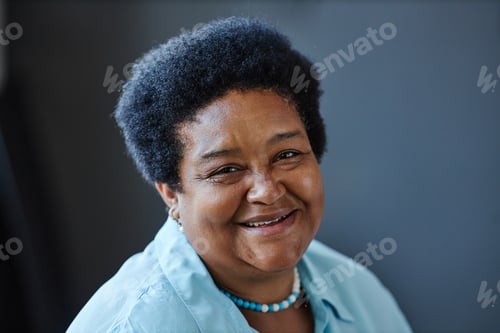 Preview: Happy mature African American female pensioner in blue casual shirt