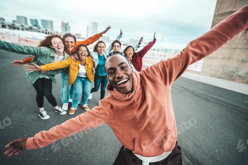 Preview: Group of young people laughing together at camera outdoors