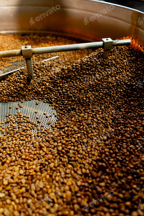 Preview: close-up of a coffee roasting factory inside drum roasting stirring coffee