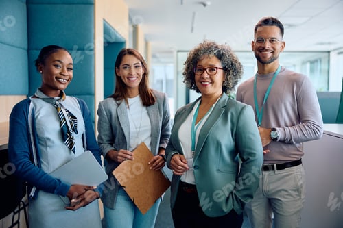 Preview: Happy multiracial business team in the office looking at camera.