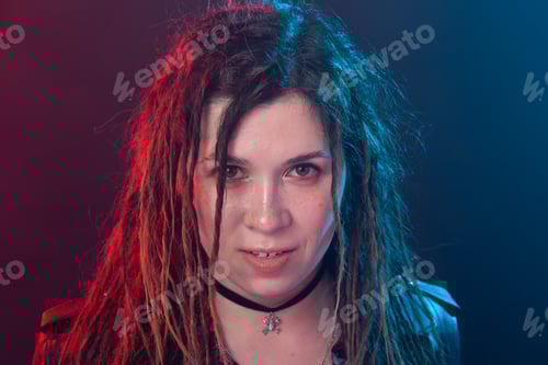 Preview: Youth, hairstyle and modern concept - young woman with dreadlocks over the red and blue light