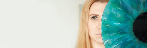 Preview: Caucasian female adult with blue artwork eye covering half of face in abstract