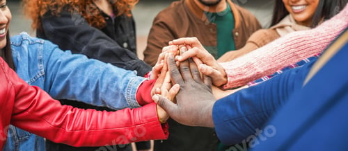 Preview: Young multiracial people stacking hands outdoor