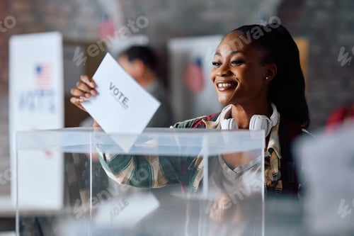 Preview: American female citizen casting her ballot while voting at polling place.
