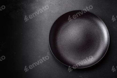 Preview: Empty beautiful black ceramic plate on a dark concrete background