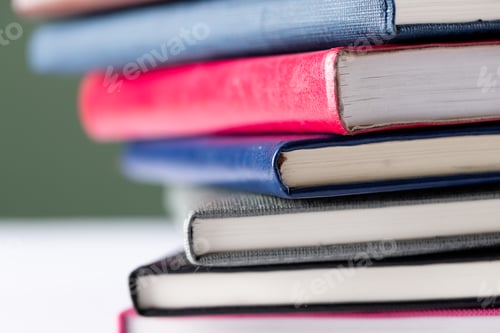 Preview: Close up of stack of books with copy space on green background