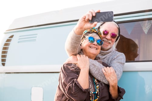 Preview: Cheerful old senior people couple hug and enjoy