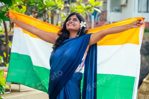 Preview: beautuful woman holding Indian flag tricolour ,wearing blue tradition sari on sea beach in Goa