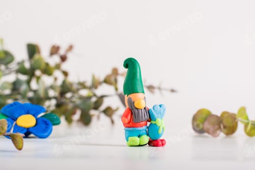 Preview: Gnome from polymer clay on a light background. Handmade decor