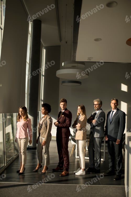 Preview: Multiethnic corporate staff standing in row and looking in the camera