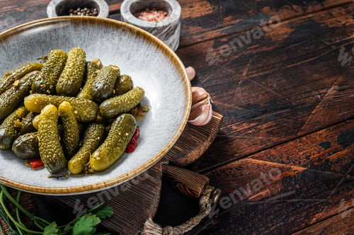 Preview: Plate with Pickled gherkins cucumbers on wooden board. Wooden background. Top view. Copy space