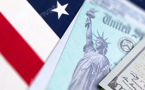 Preview: United States IRS Check, Envelope and Money Resting on American Flag