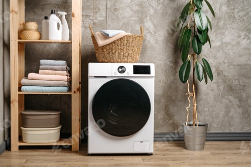 Preview: Laundry room interior with washing machine near gray grunge wall