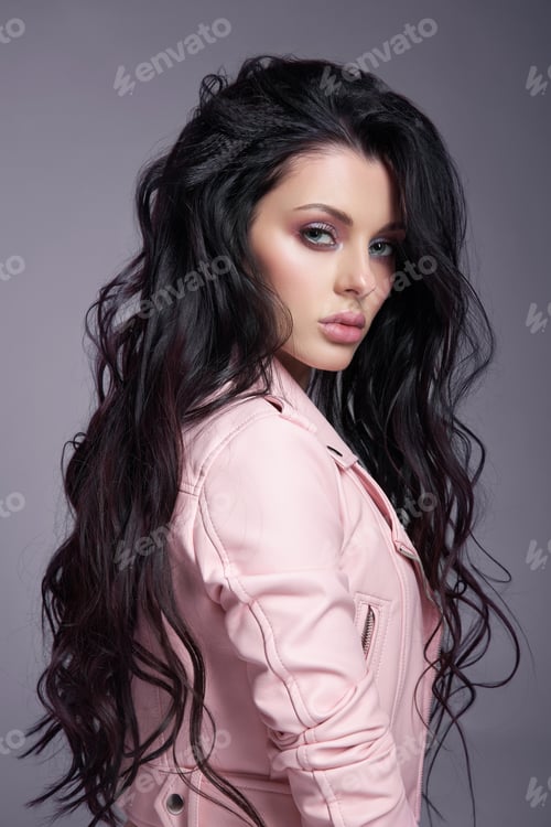 Preview: Beautiful Woman in a pink leather jacket with long hair on the floor. Sexy brunette girl